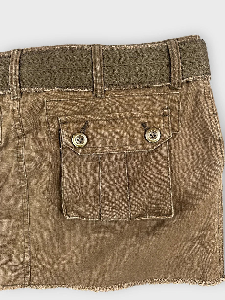 Detail view of brown mini skirt featuring unique belt and back pocket design.
