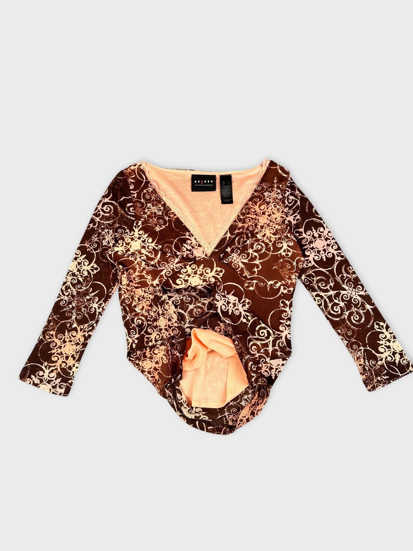 Detail view of brown sheer long sleeve top with floral print.