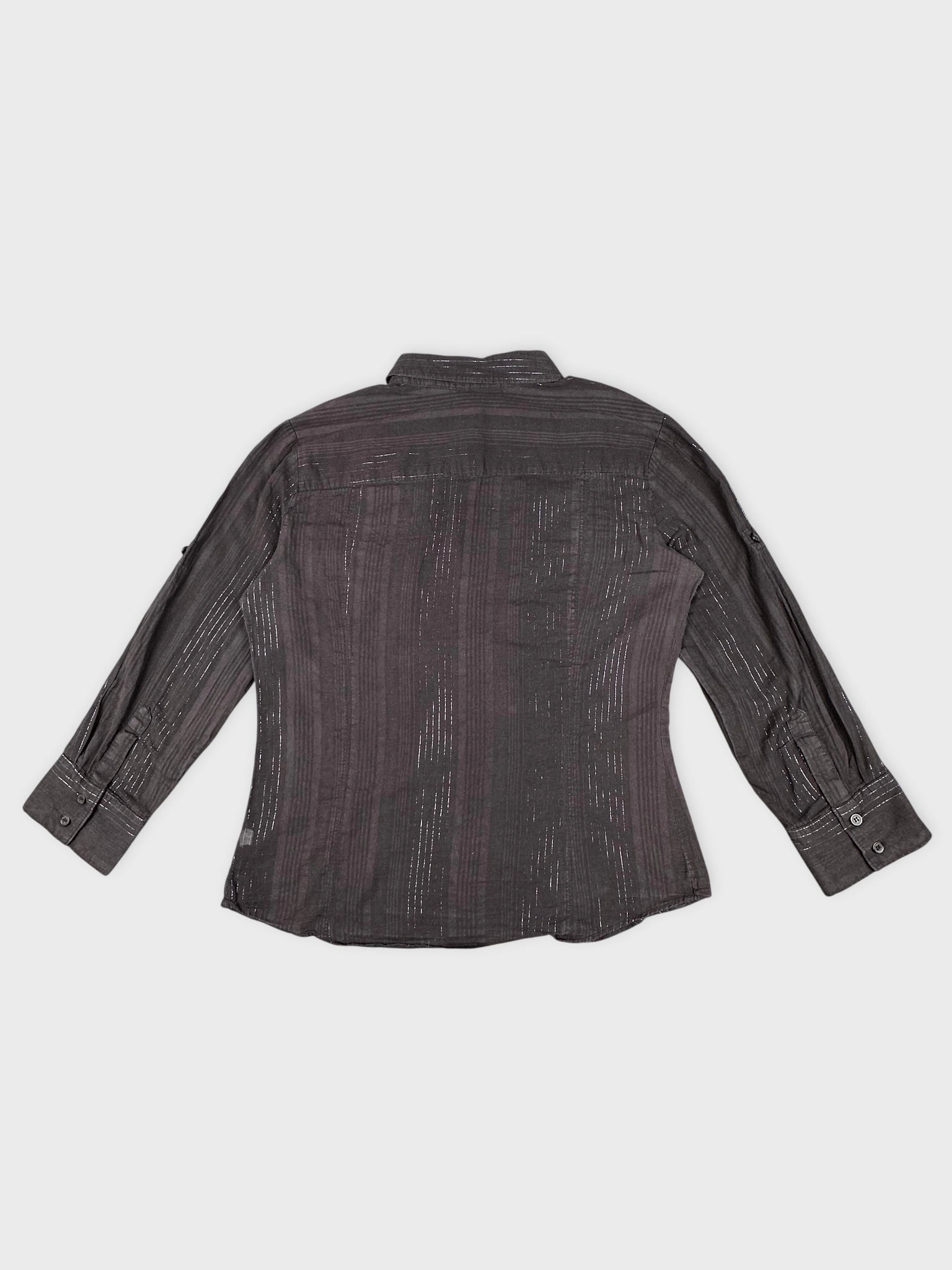 Back view of brown striped classic blouse with buttoned cuffs.