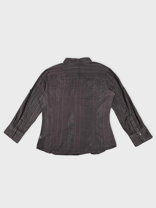 Back view of brown striped classic blouse with buttoned cuffs.