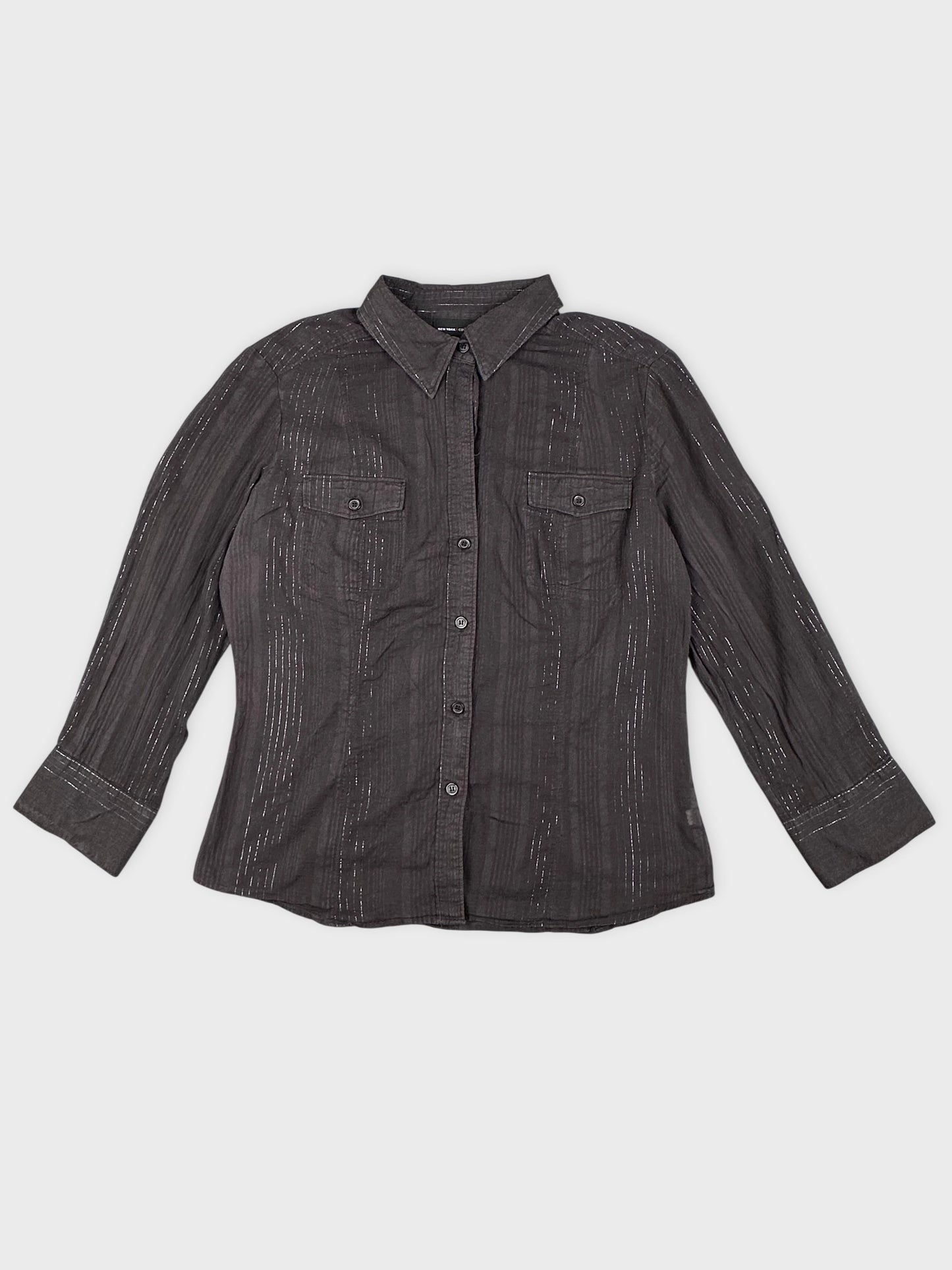 Detail view of a brown striped classic shirt featuring a button-down front.