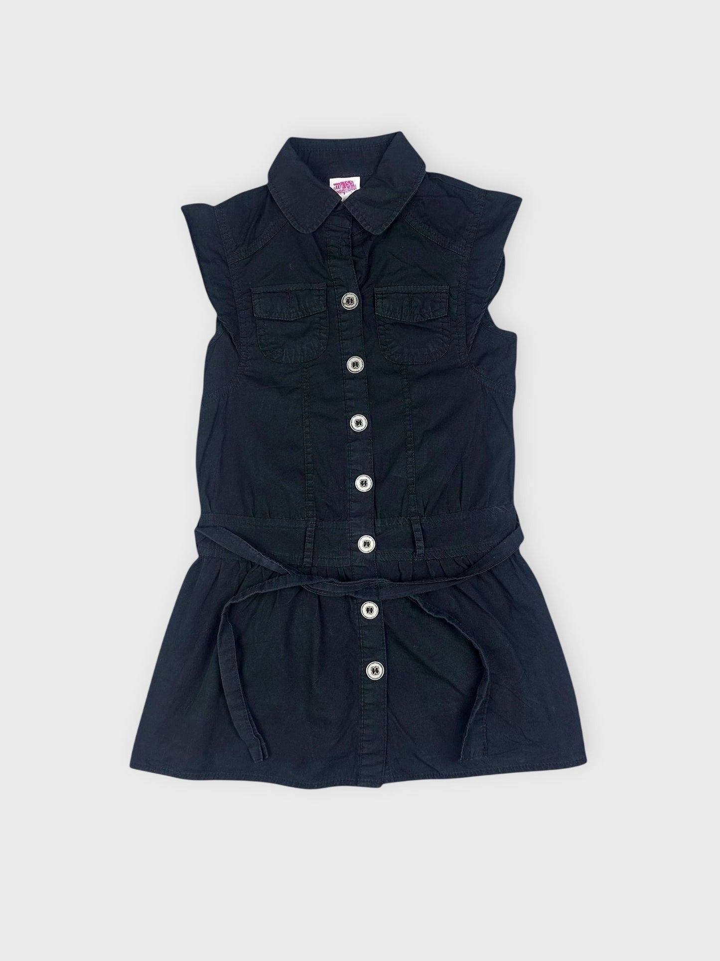 Detail view of a black button-down top with a fitted waist and short sleeves.
