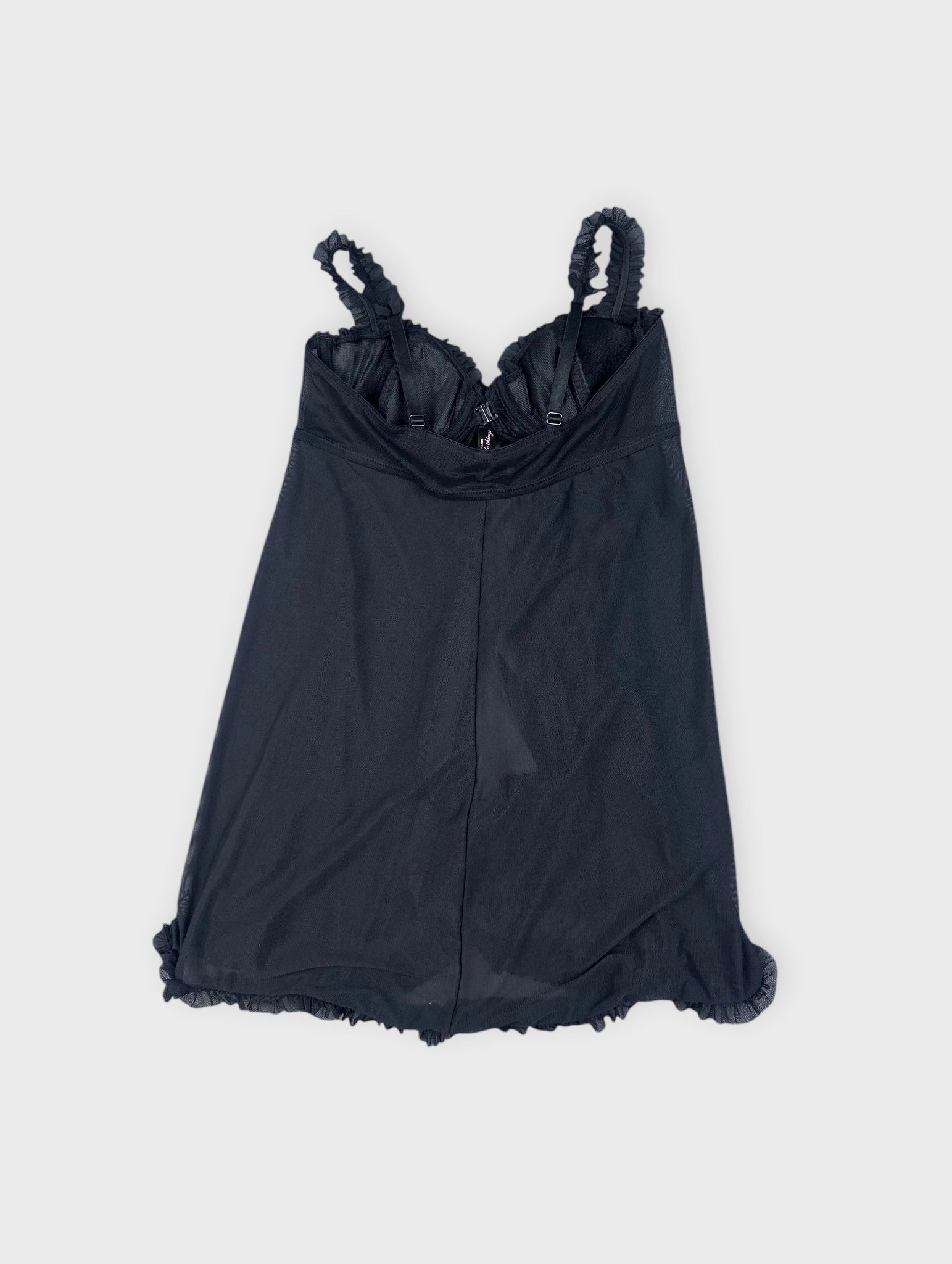 Back view of a black camisole featuring ruffled straps and hem.
