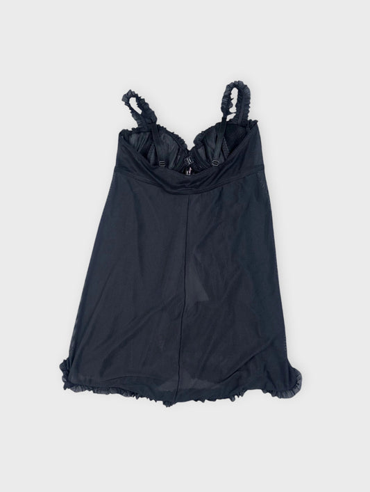 Back view of a black camisole featuring ruffled straps and hem.
