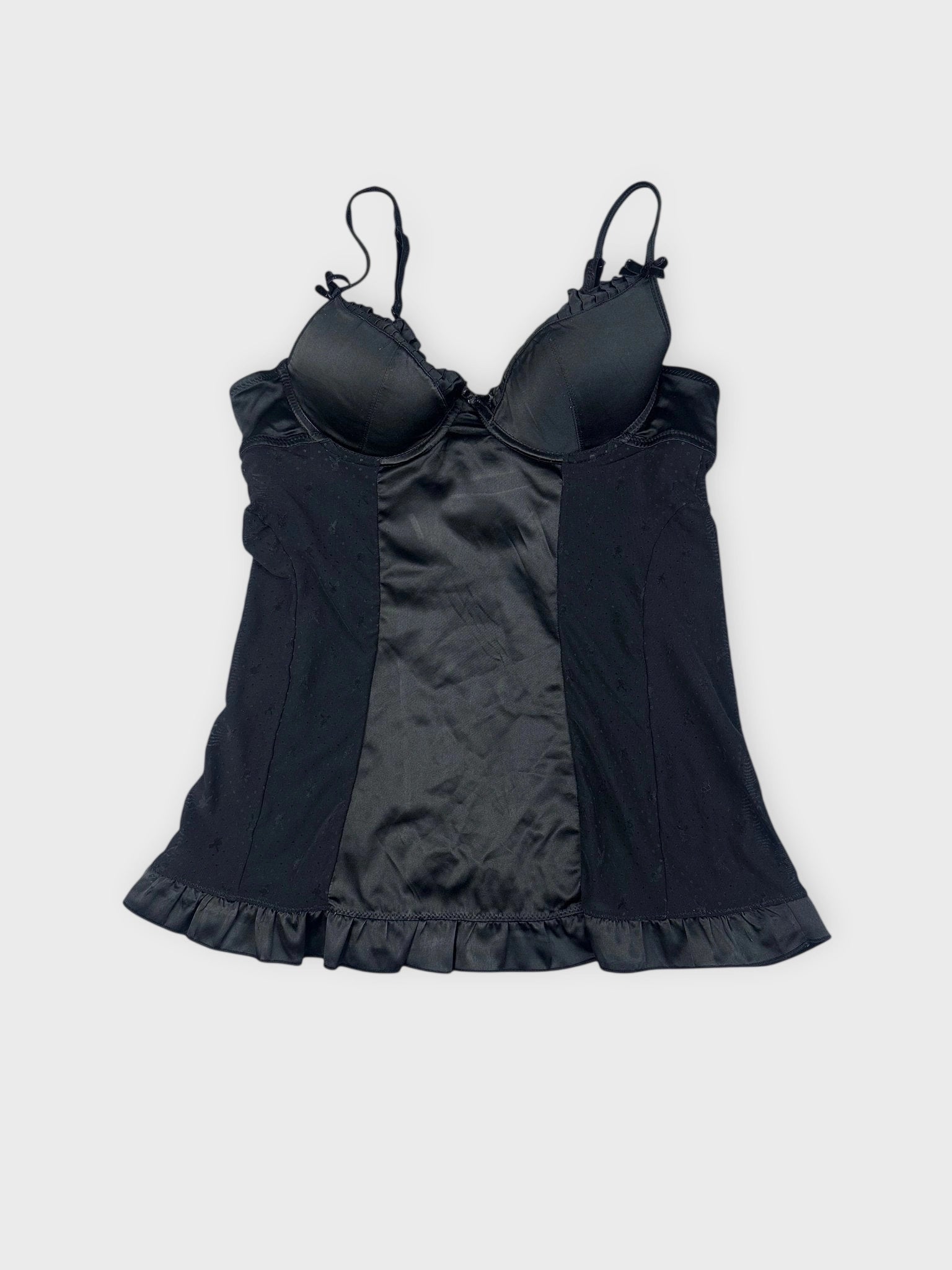 Black camisole front view with ruffled hem detail.