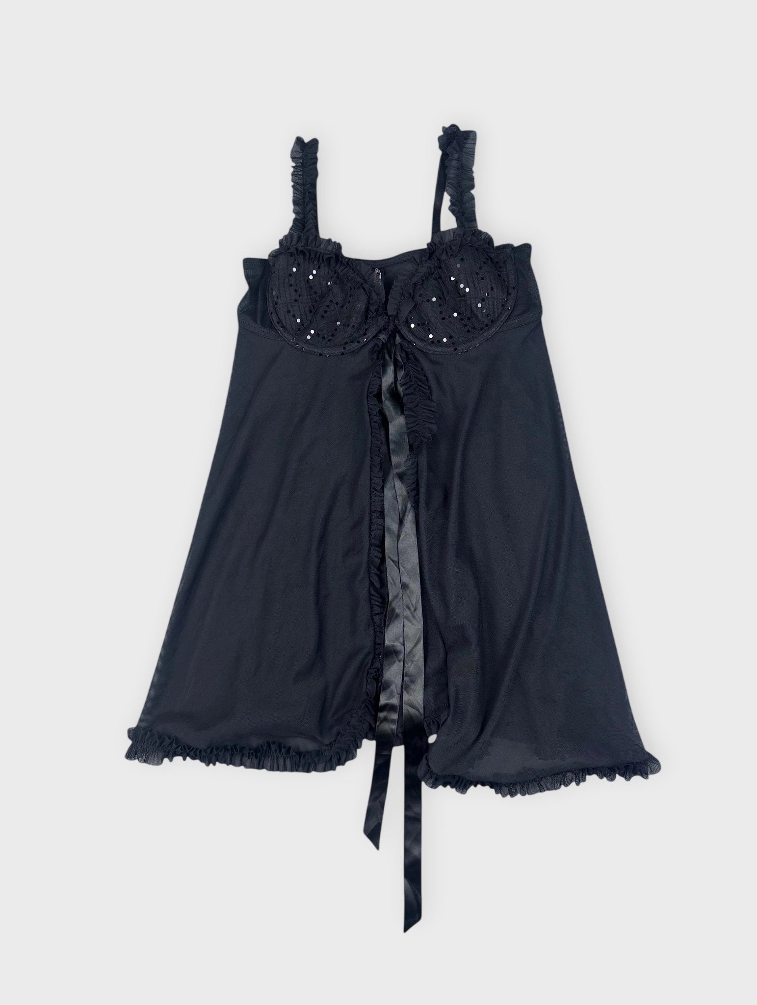 Front view of black camisole featuring ruffled trim and decorative sequins.