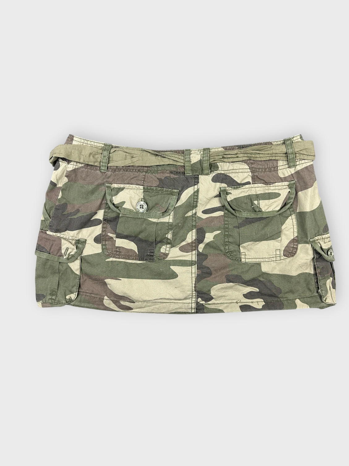 Back view of camo mini skirt showing pocket details and tie waist.