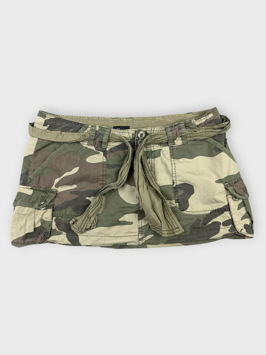 Camo mini skirt with tie waist shown in front view, featuring camouflage pattern.