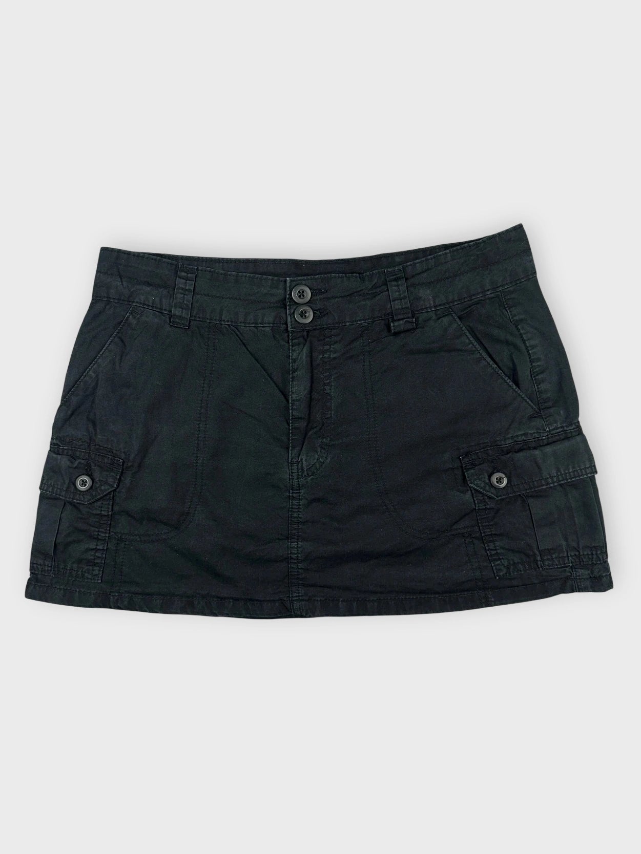 Casual black mini skirt with pockets front view featuring button details.