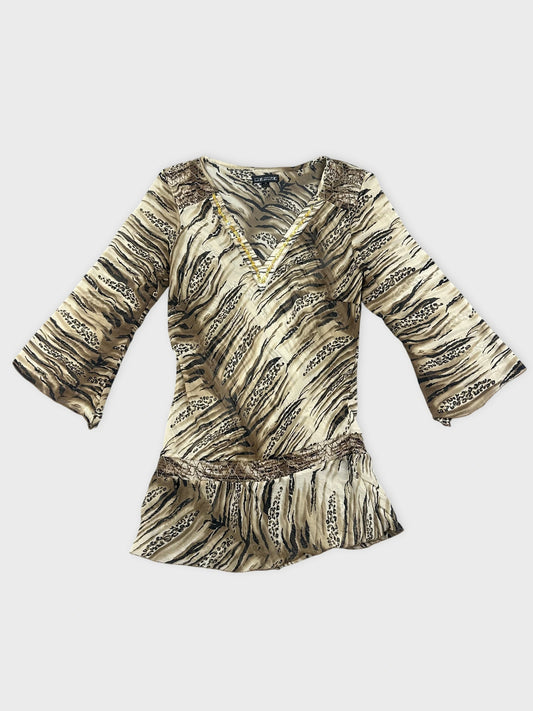 Chic animal print blouse with lace detail front view in beige and black.