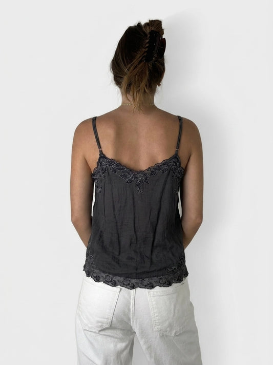 Back view of a black camisole featuring lace trim detail.