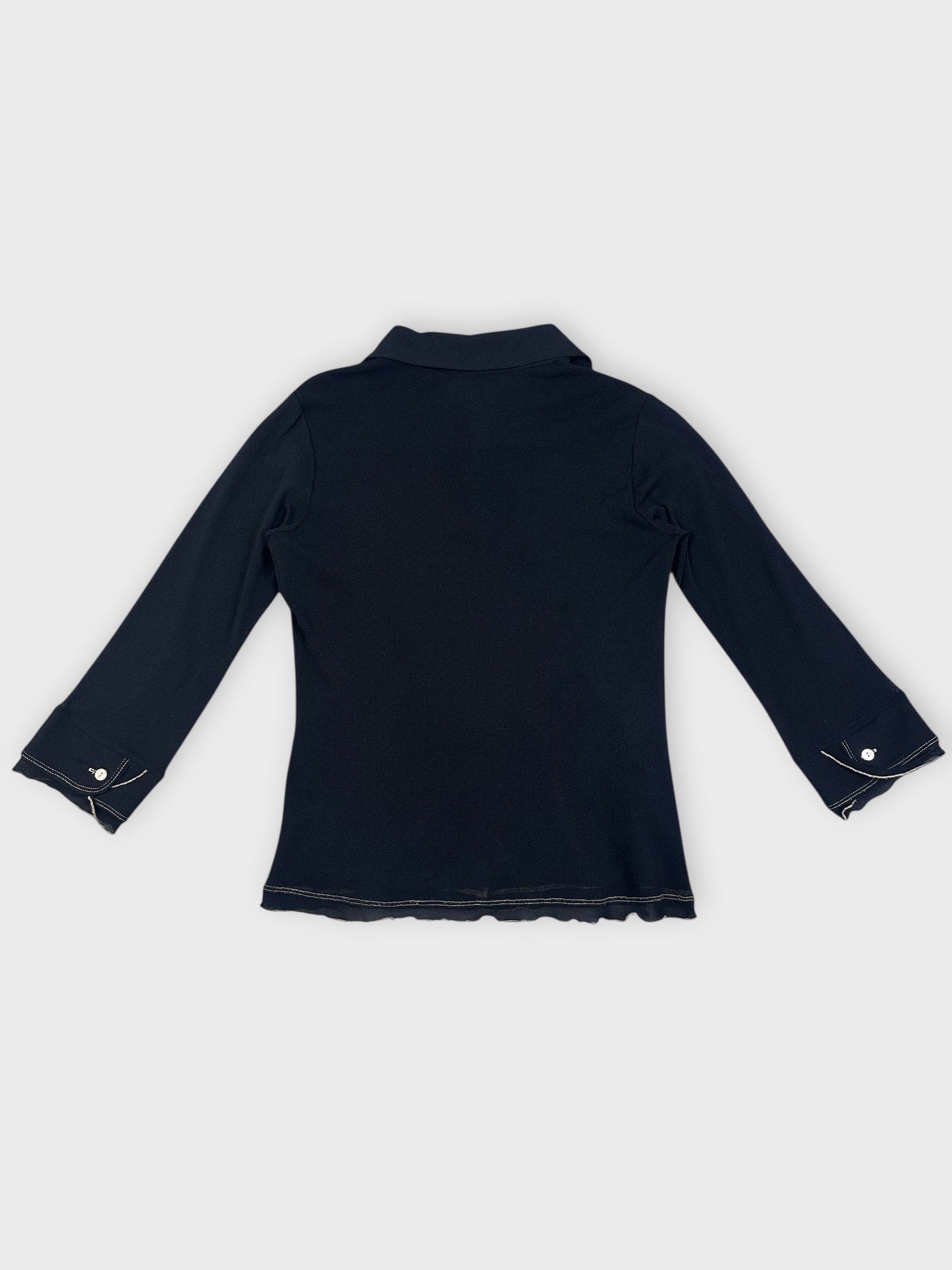 Back view of a black collared shirt with ruffled hem