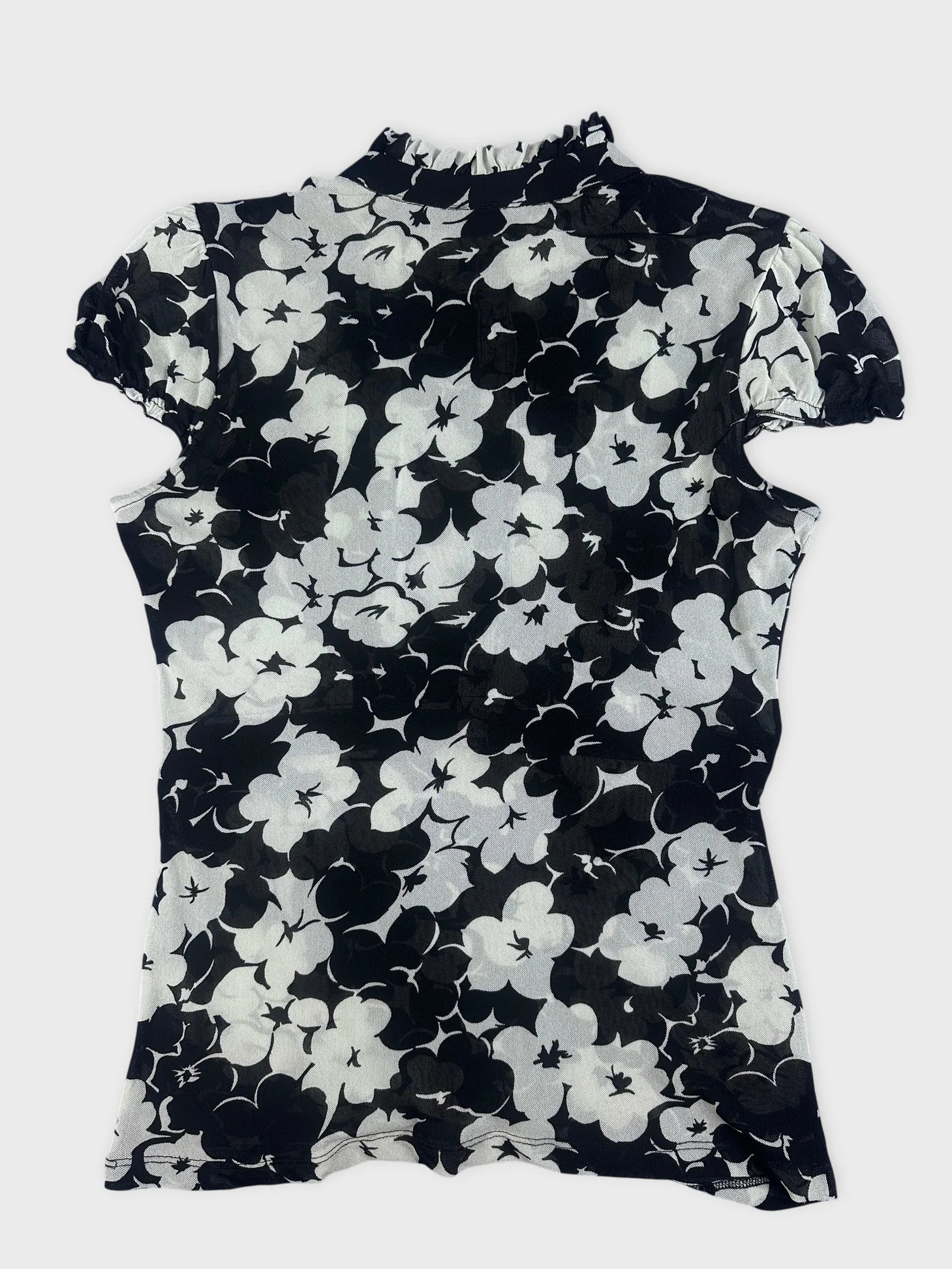 Back view of a black floral playsuit with ruffle detail.