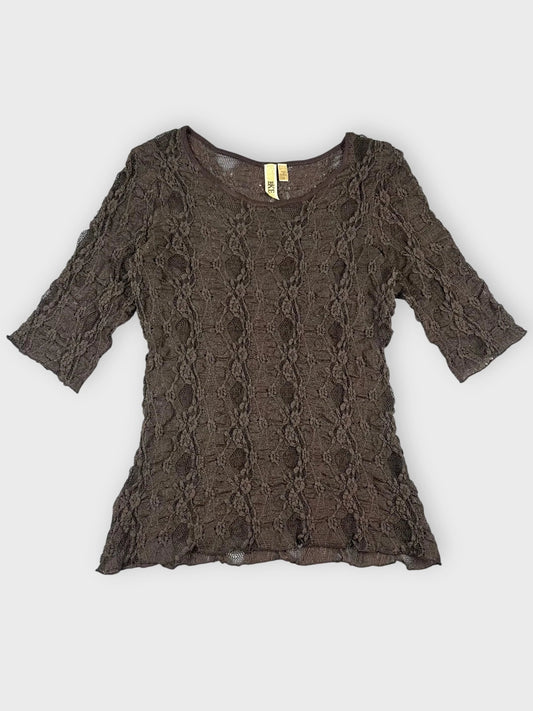 Front view of a black lace top with short sleeves and floral pattern.