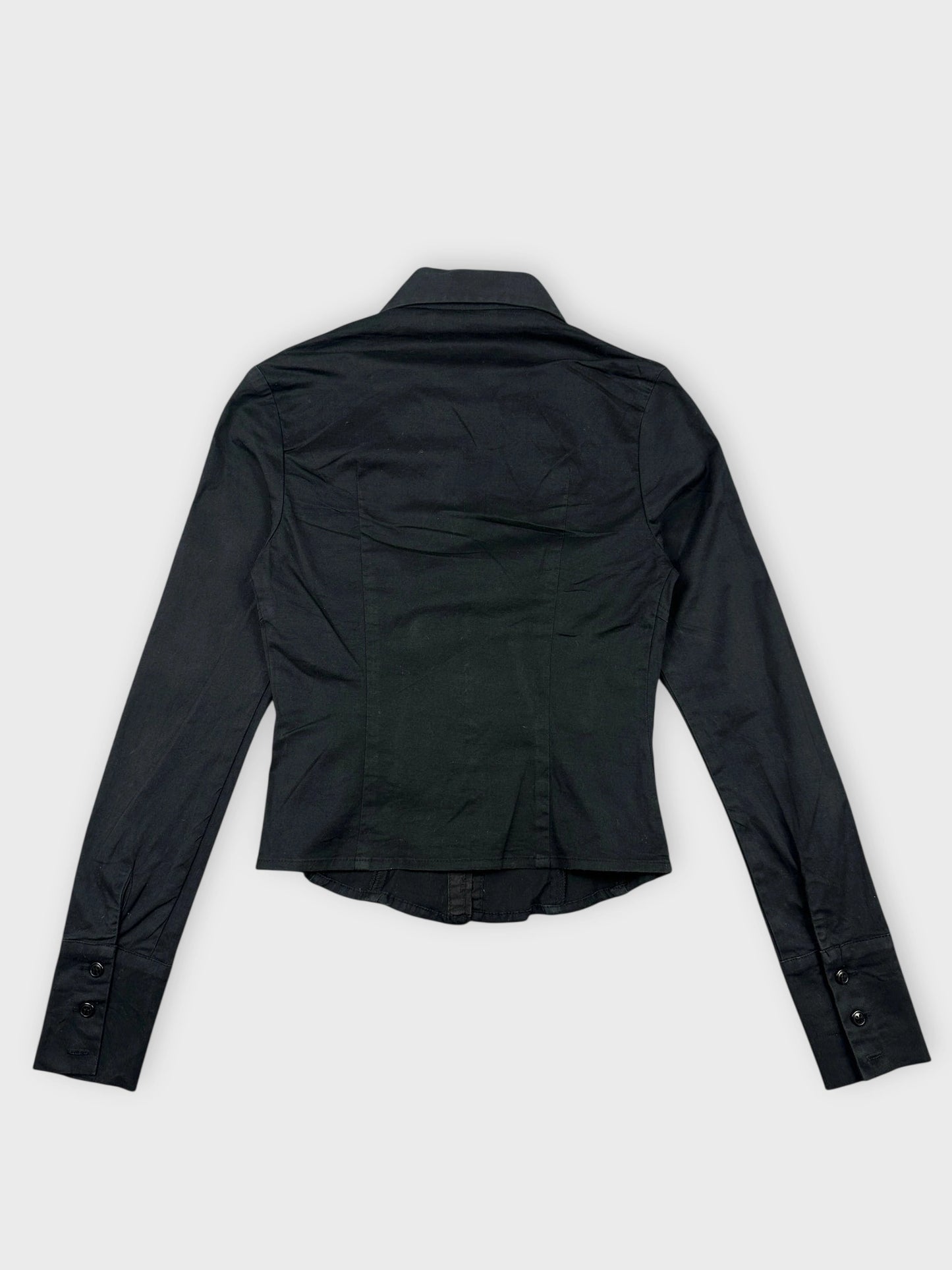 Back view of a black long sleeve cropped button-up shirt with a collar.