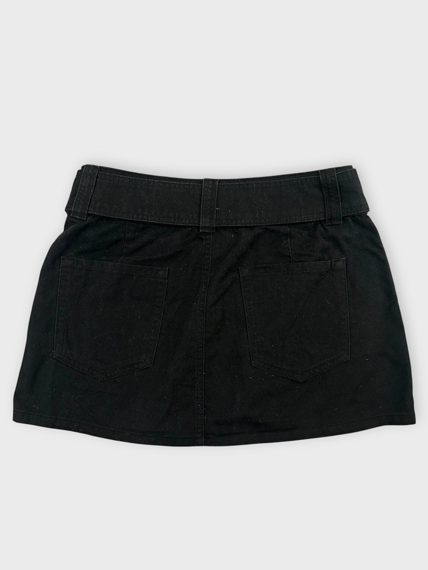 Back view of a black mini skirt with adjustable belt and pockets.