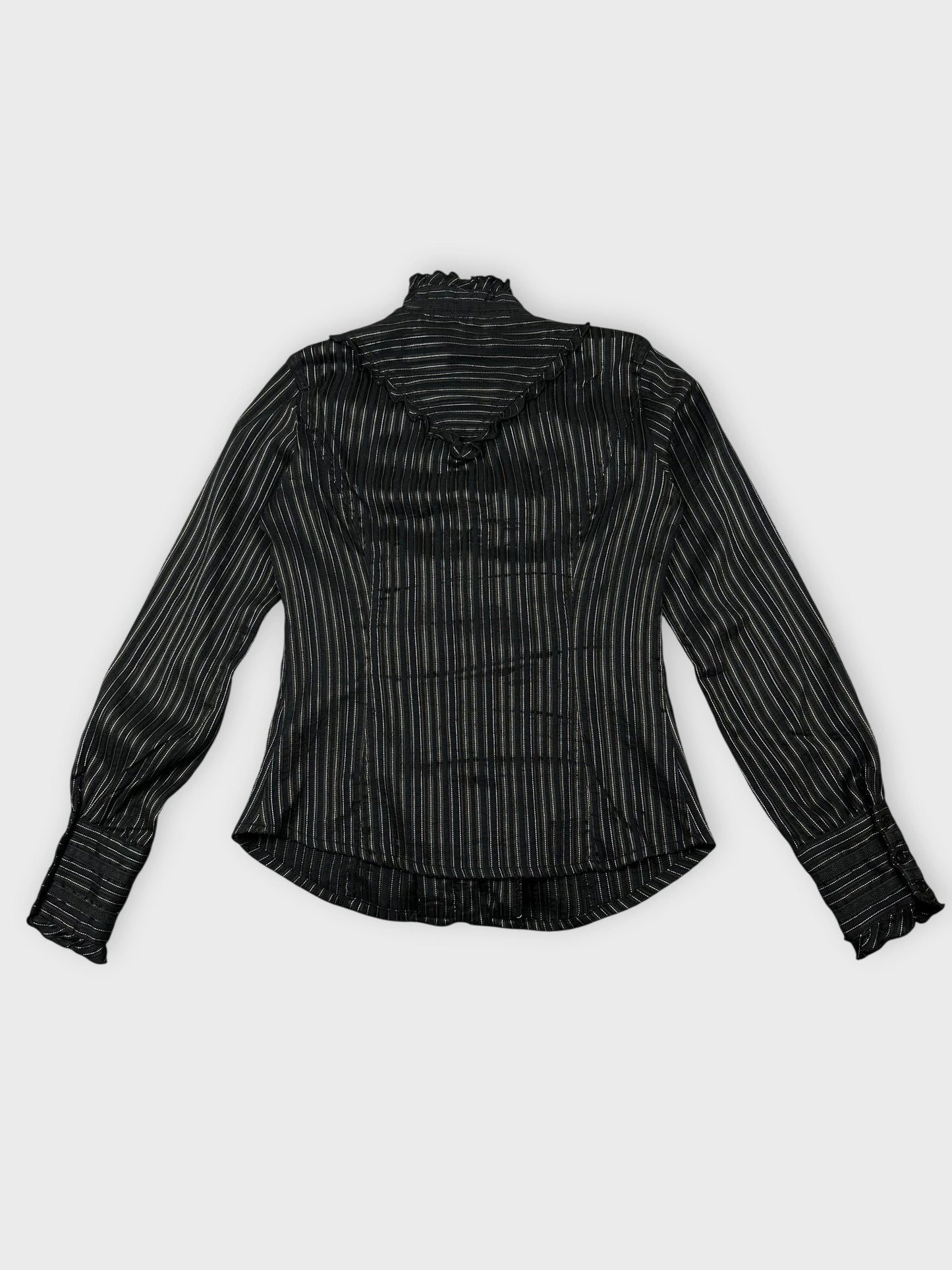 Back view of black striped blouse with ruffled hem detail.