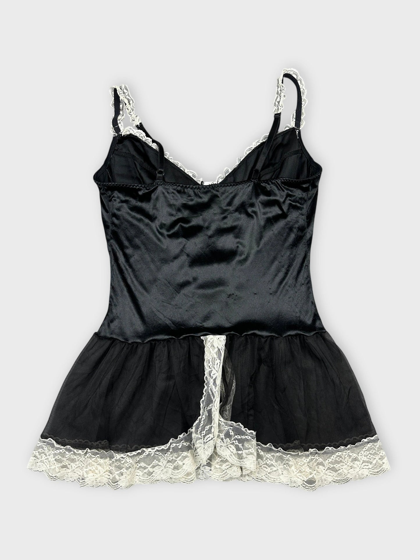 Back view of black satin top featuring lace trim details.
