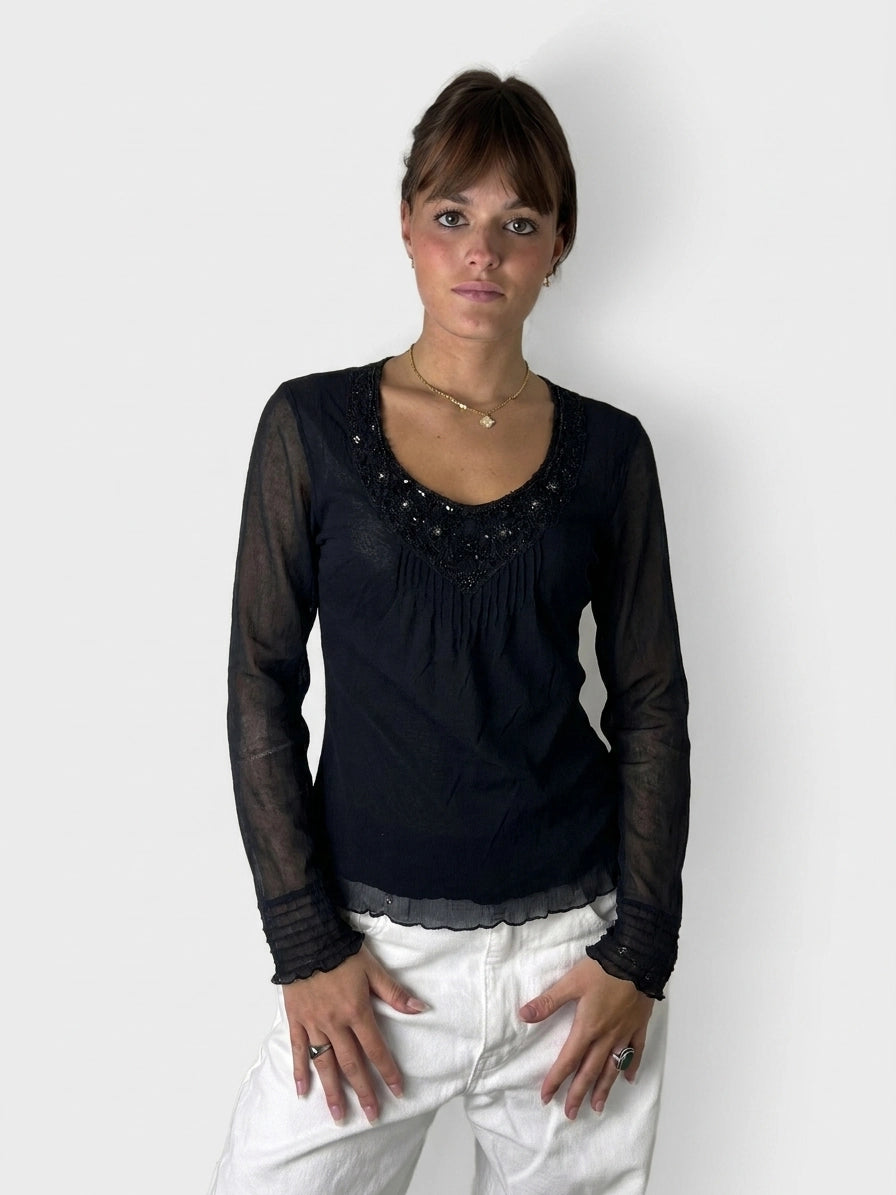 Chic black sheer top with embellished detail, front view, featuring a scoop neck.