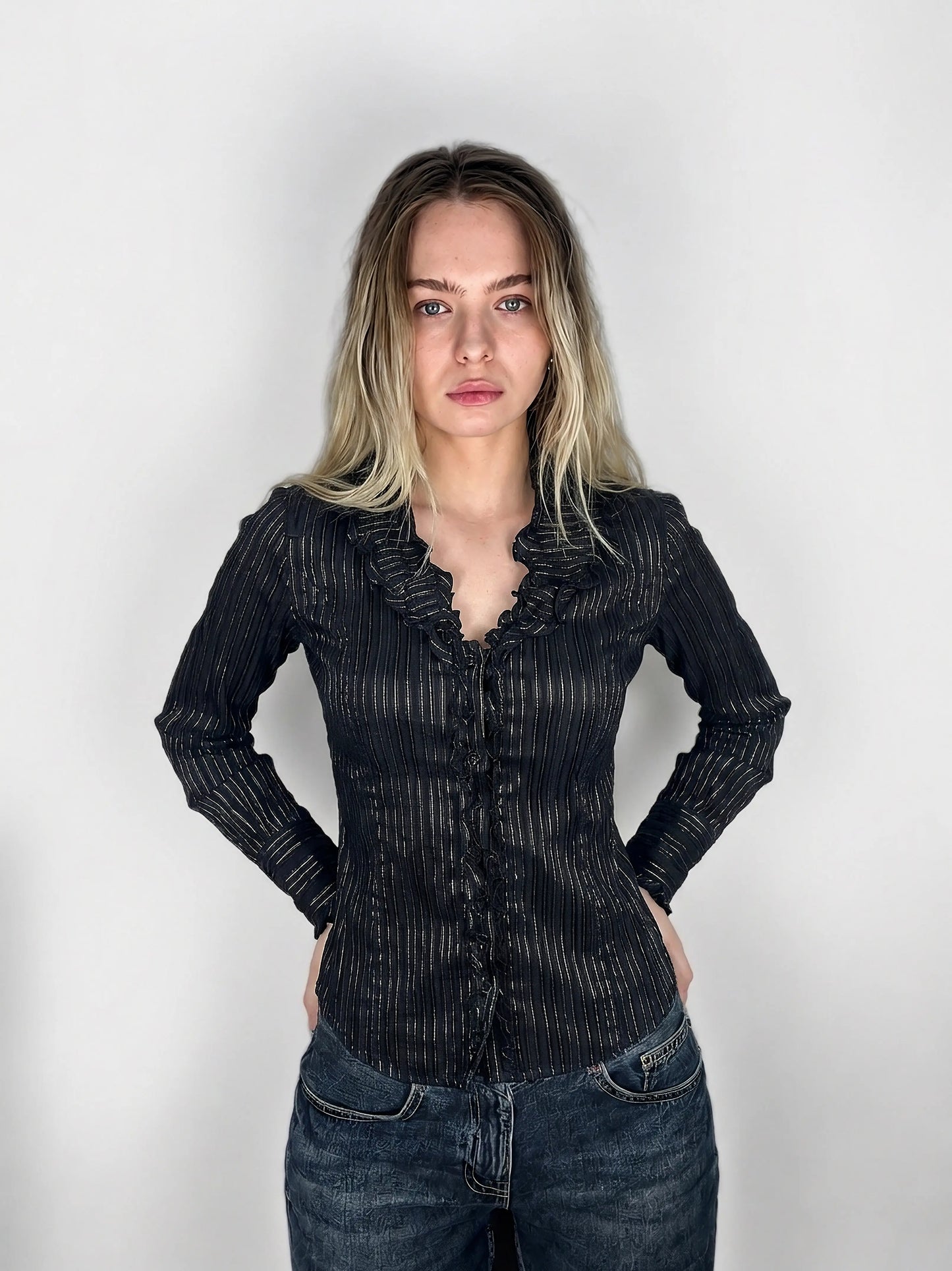 Chic black striped ruffled blouse with front view showing intricate ruffle detail.