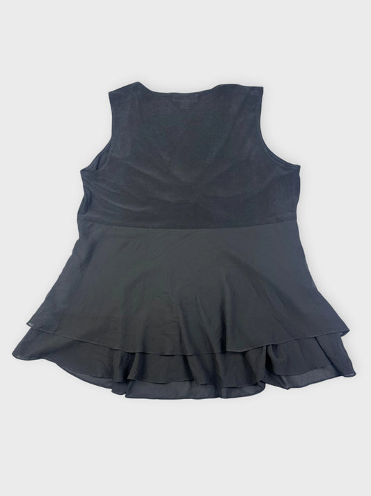 Back view of a black top featuring a flared design.