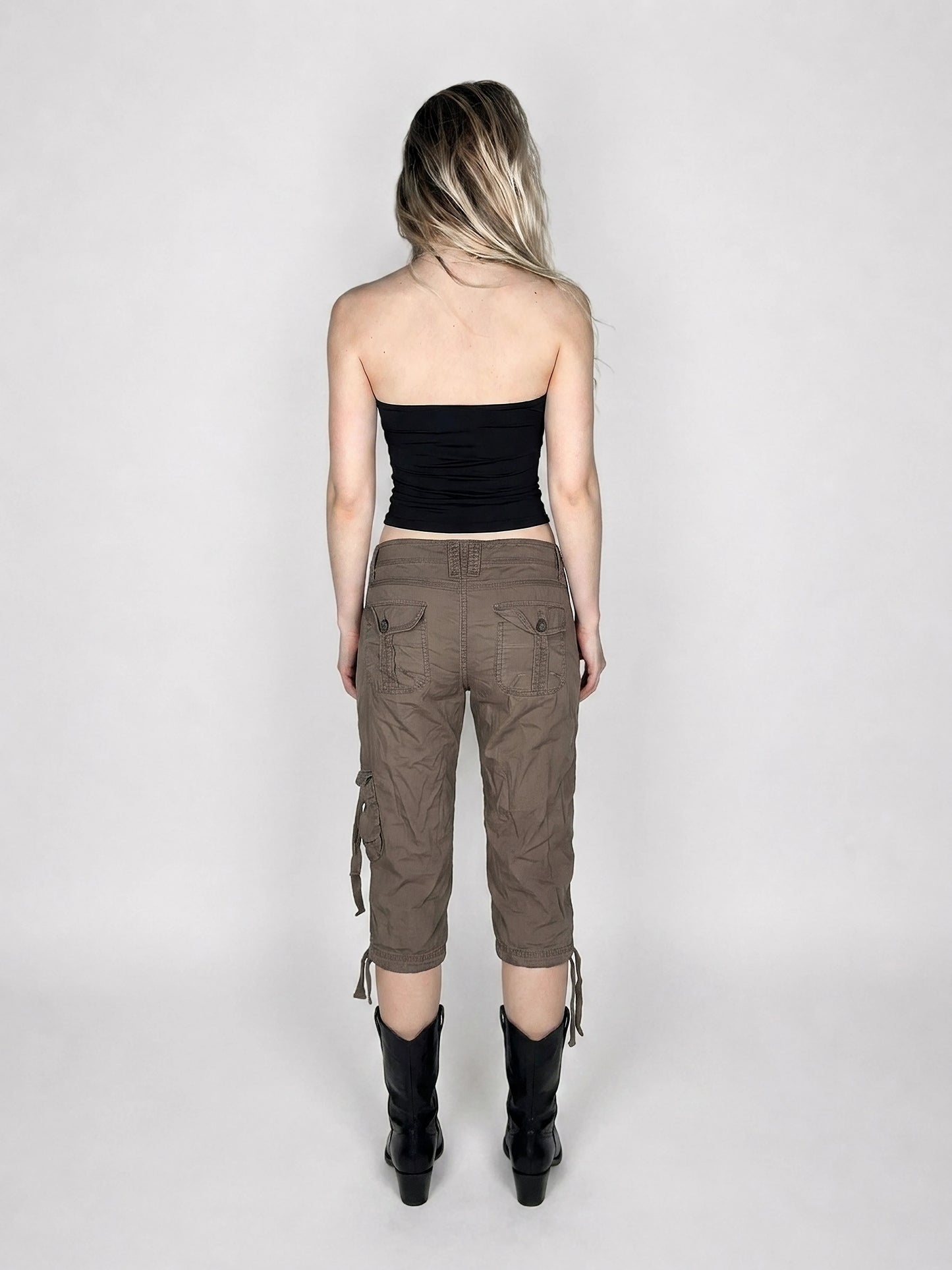 Back view of brown cargo shorts with drawstrings and side pockets.
