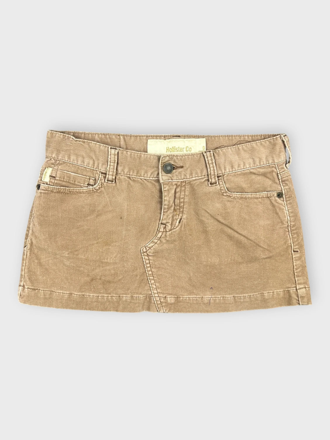 Chic brown denim mini skirt with side pockets front view
