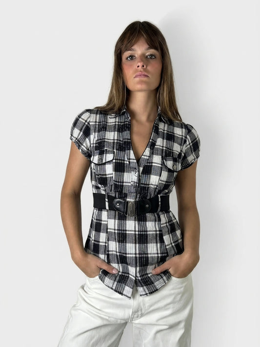 Chic checkered short sleeve top in black and white, front view with a belted waist.