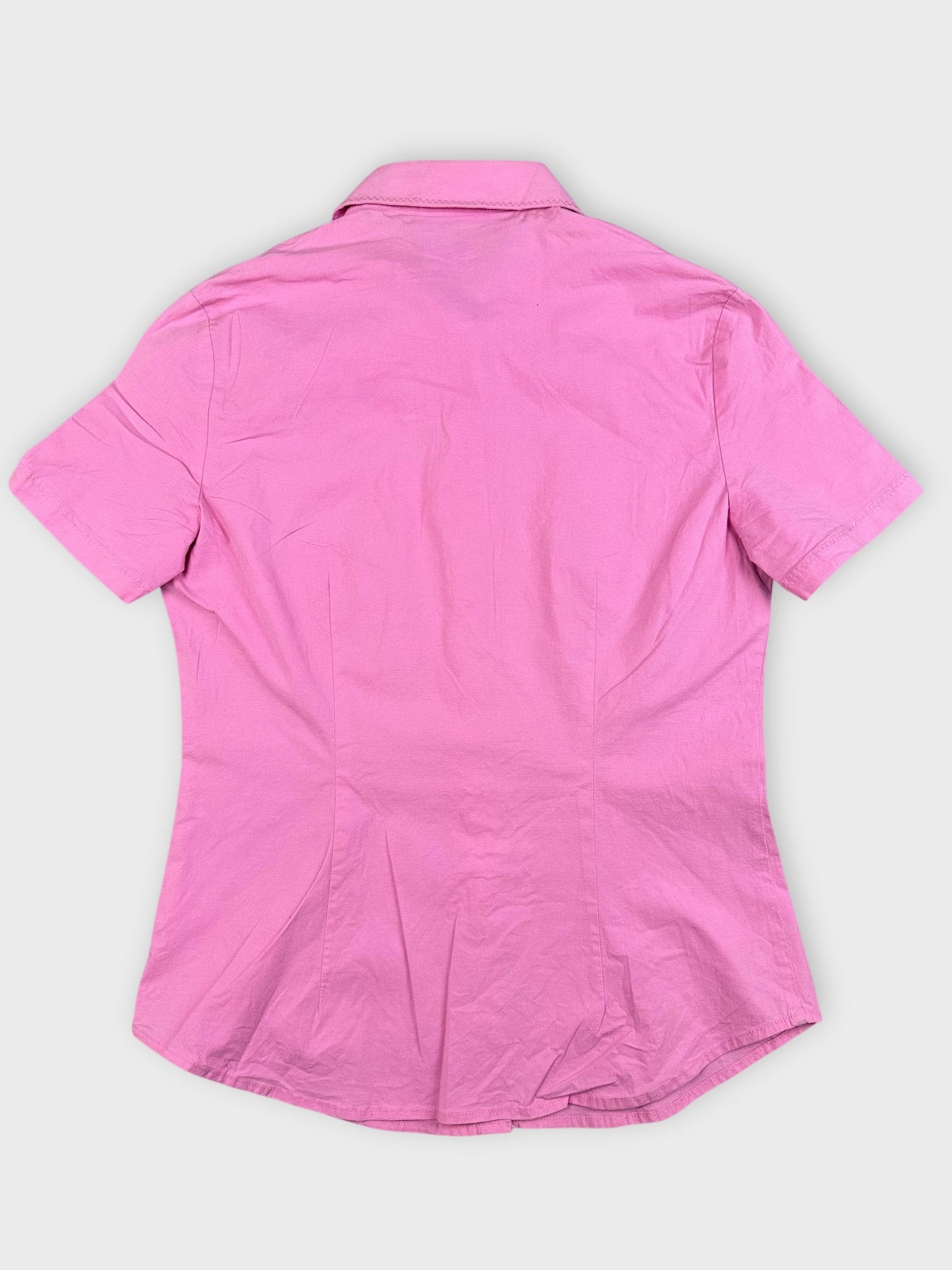 Back view of a pink cotton top featuring a tailored fit and short sleeves