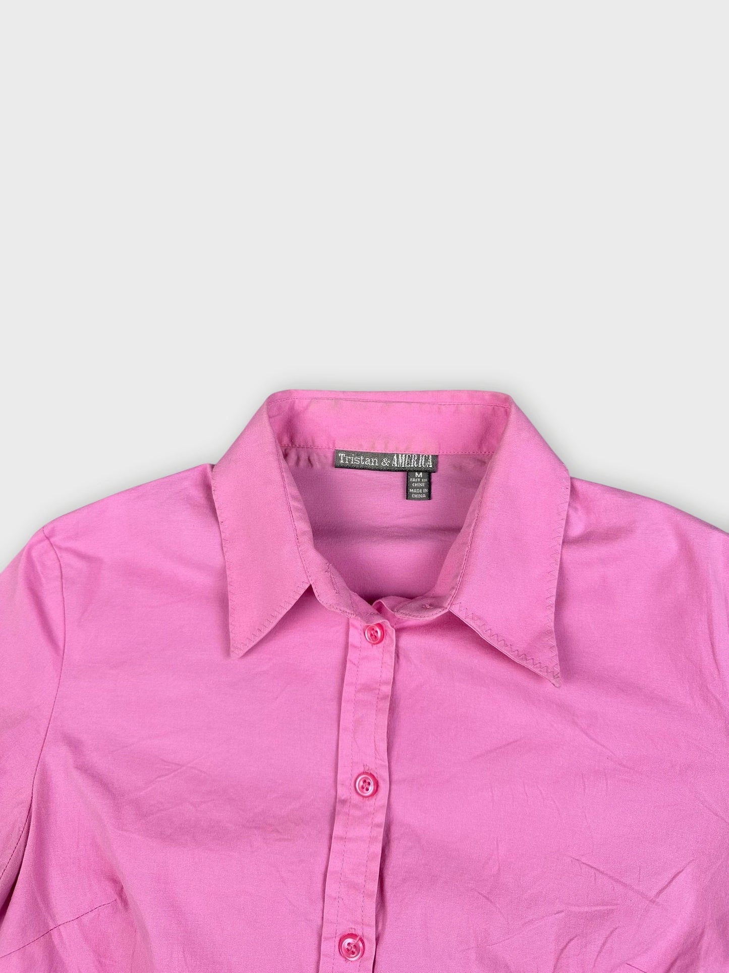 Chic cotton top in pink with button detail view.