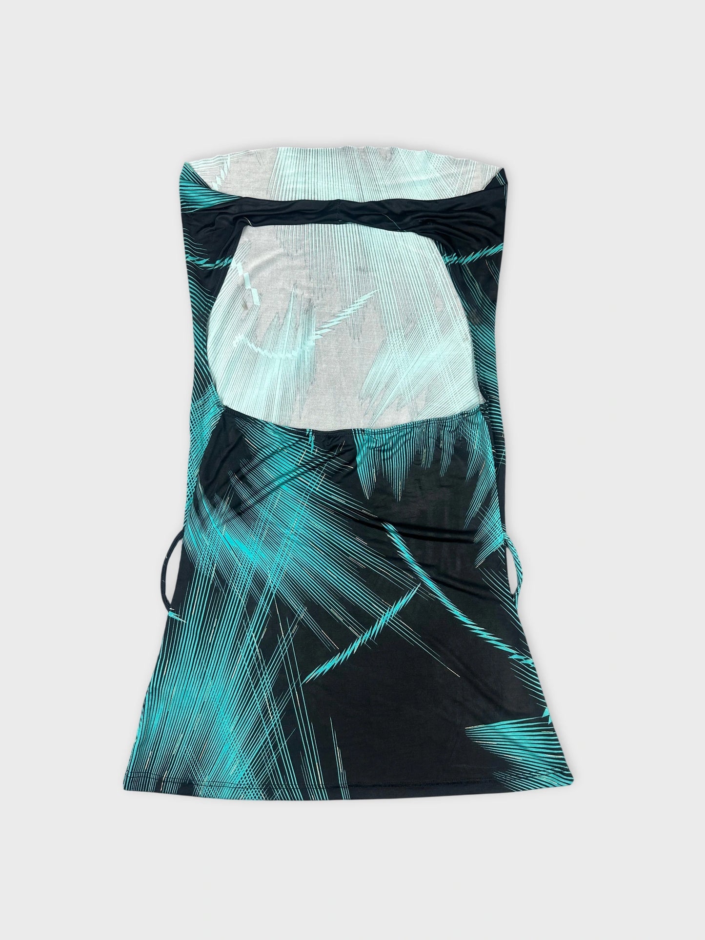 Back view of a cowl neck top in black with turquoise geometric patterns.