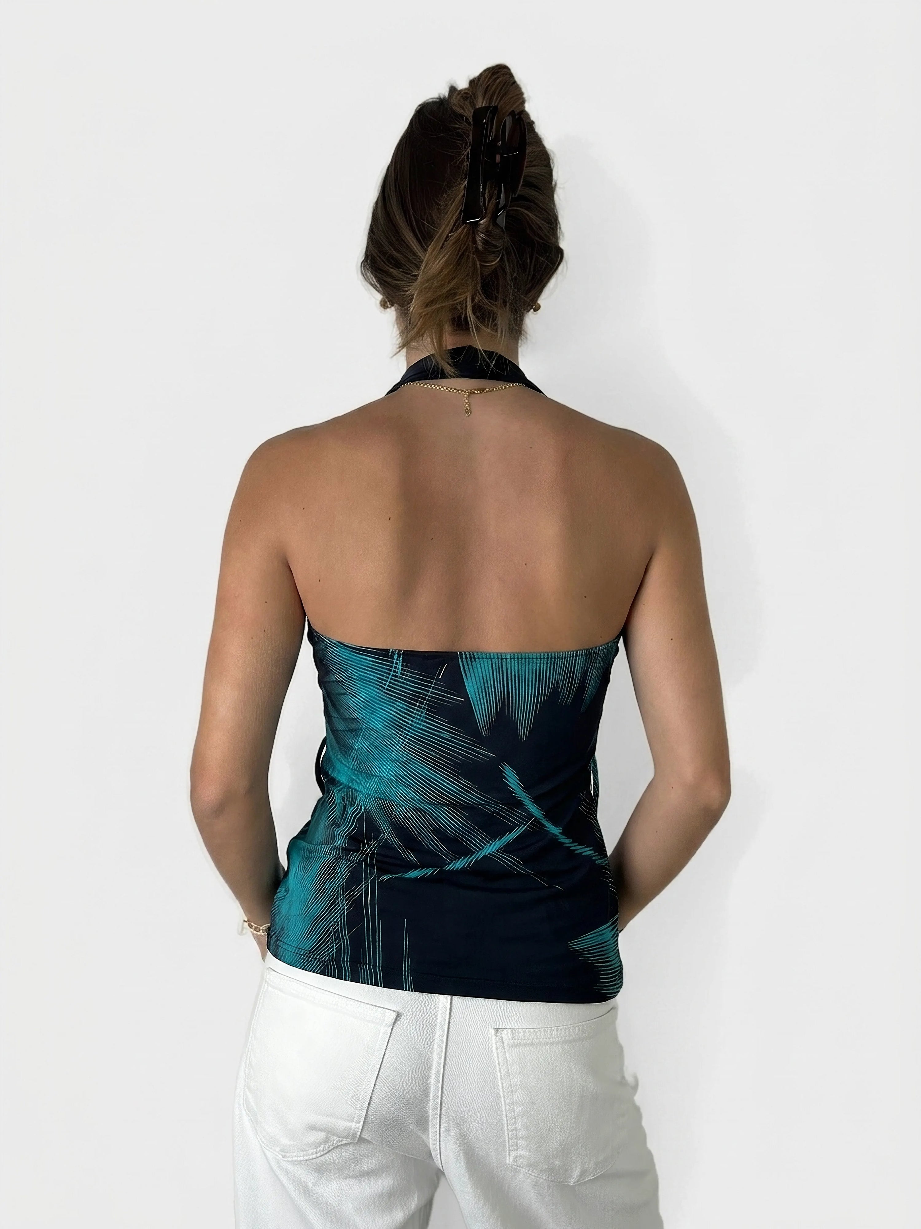 Back view of a cowl neck top in navy with edgy teal patterns.