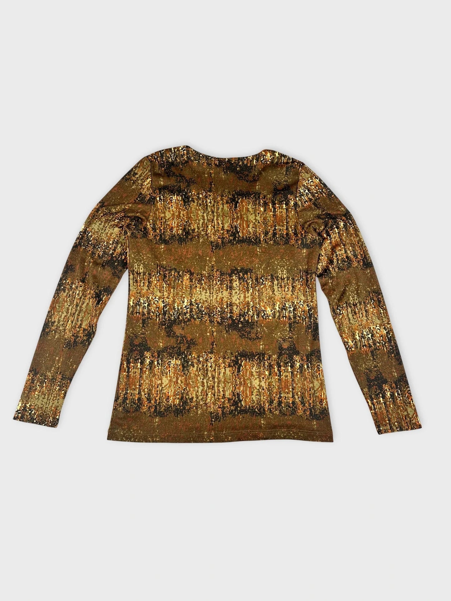 Detail view of a long sleeve top in earthy tones with a nature-inspired print.