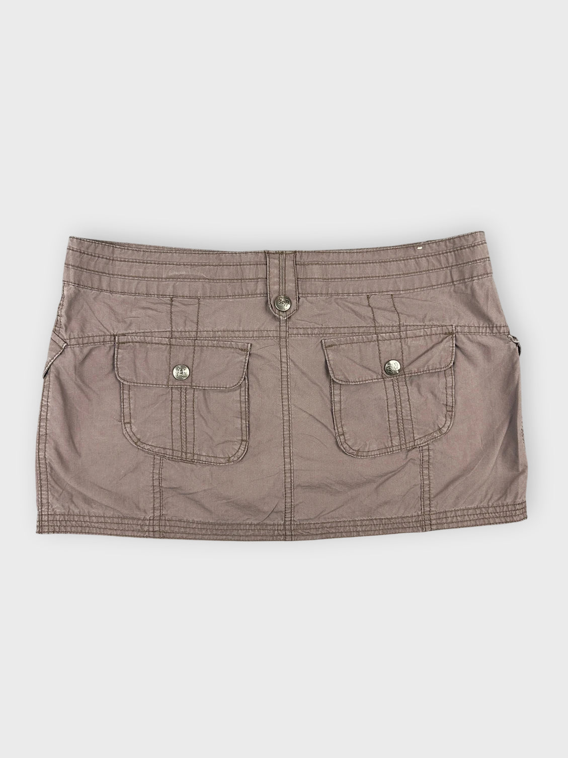 Back view of brown mini skirt with front pockets and button detailing.