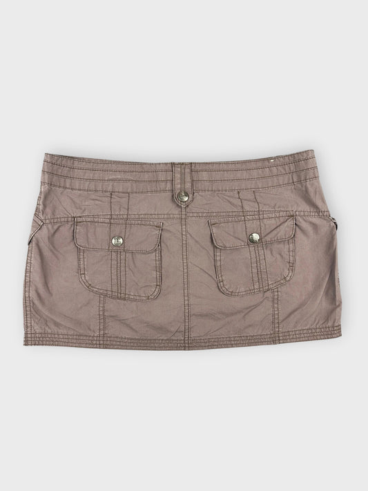 Back view of brown mini skirt with front pockets and button detailing.