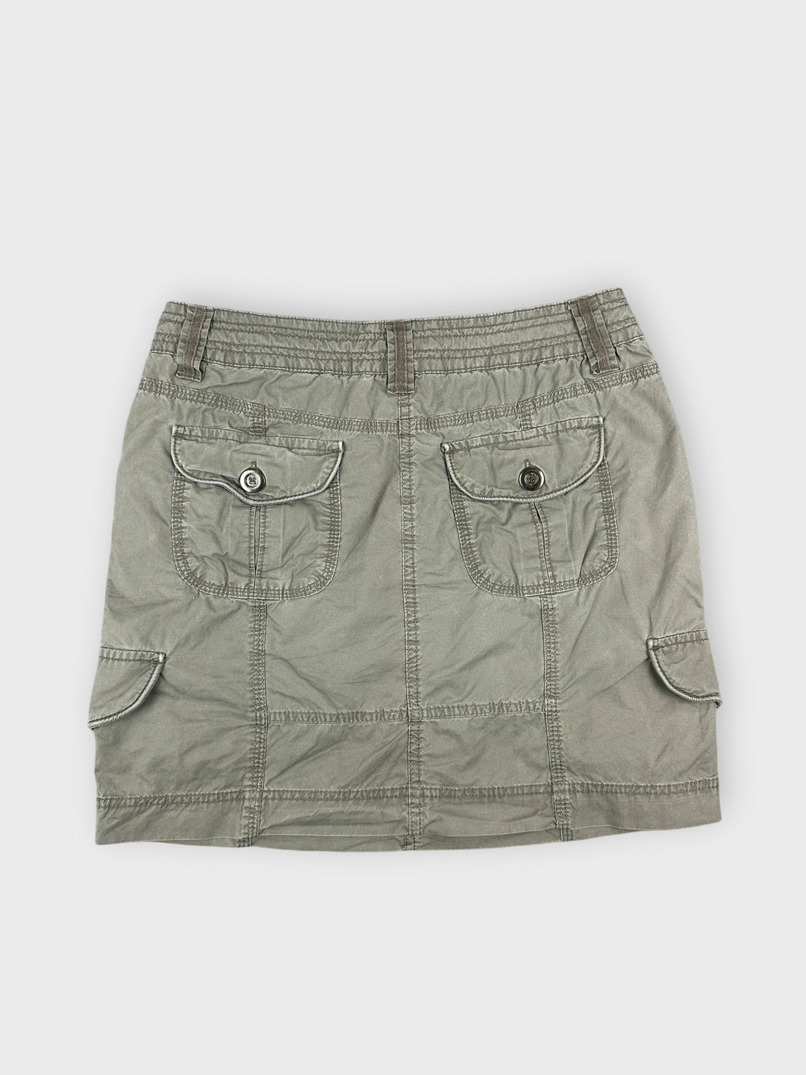 Chic olive mini skirt with structured design and pockets back view.