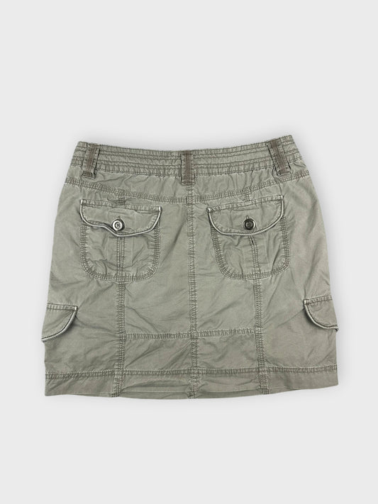 Chic olive mini skirt with structured design and pockets back view.