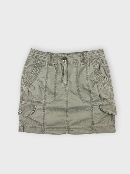 Chic olive mini skirt with smart pockets front view showcasing textured fabric and stitching