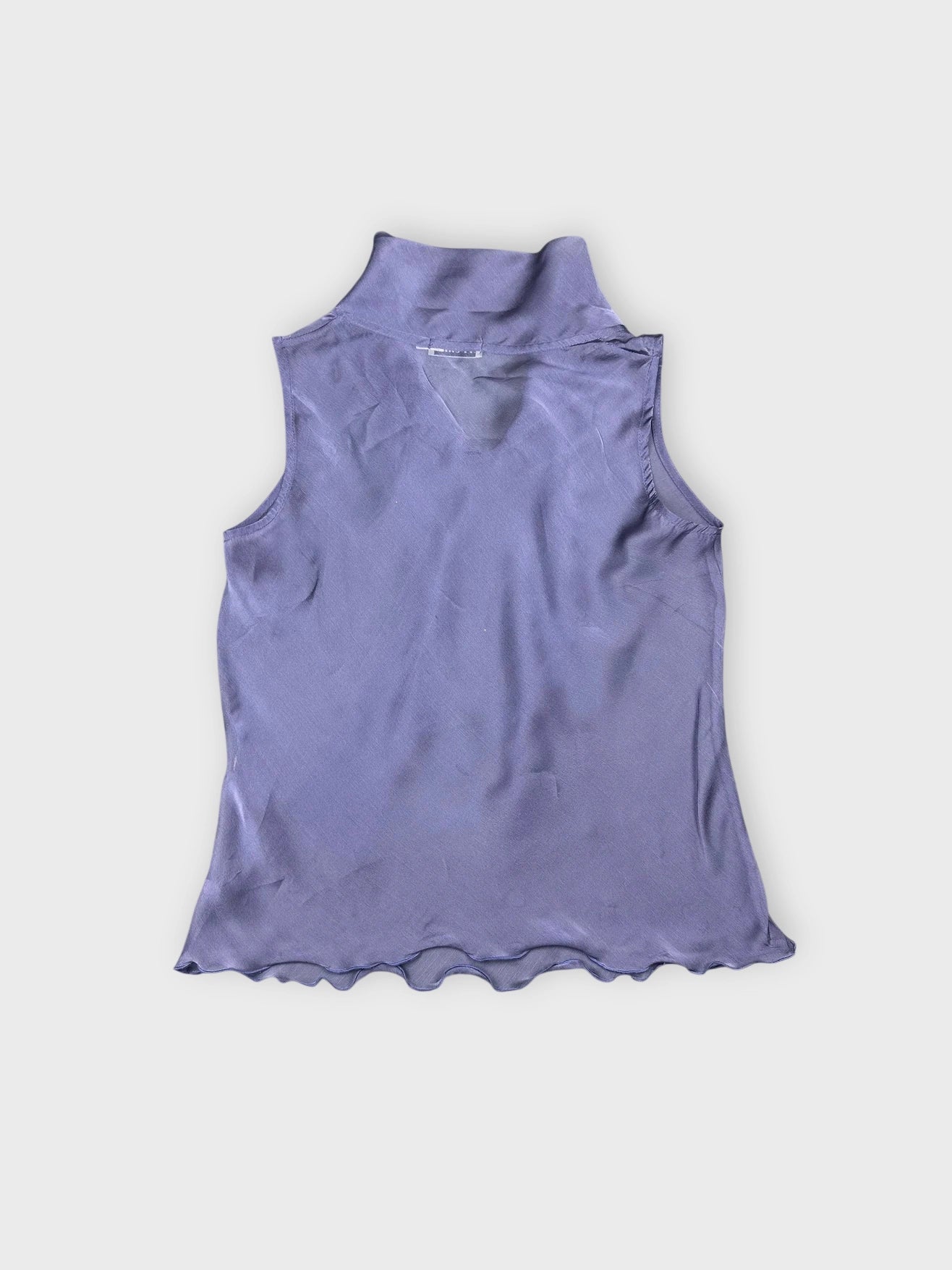 Back view of a sheer purple top featuring a draped design and scalloped hem.