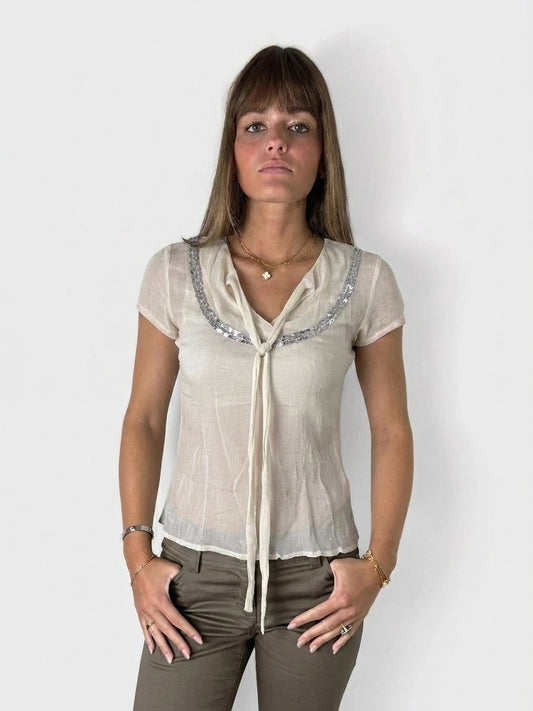 Chic silk tie-front top in cream, featuring sparkling details, front view.
