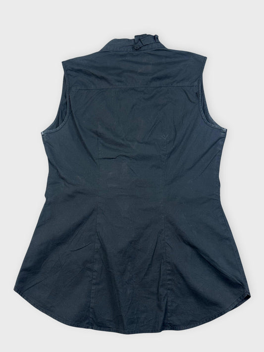 Back view of a black sleeveless ruffled top with a structured design.