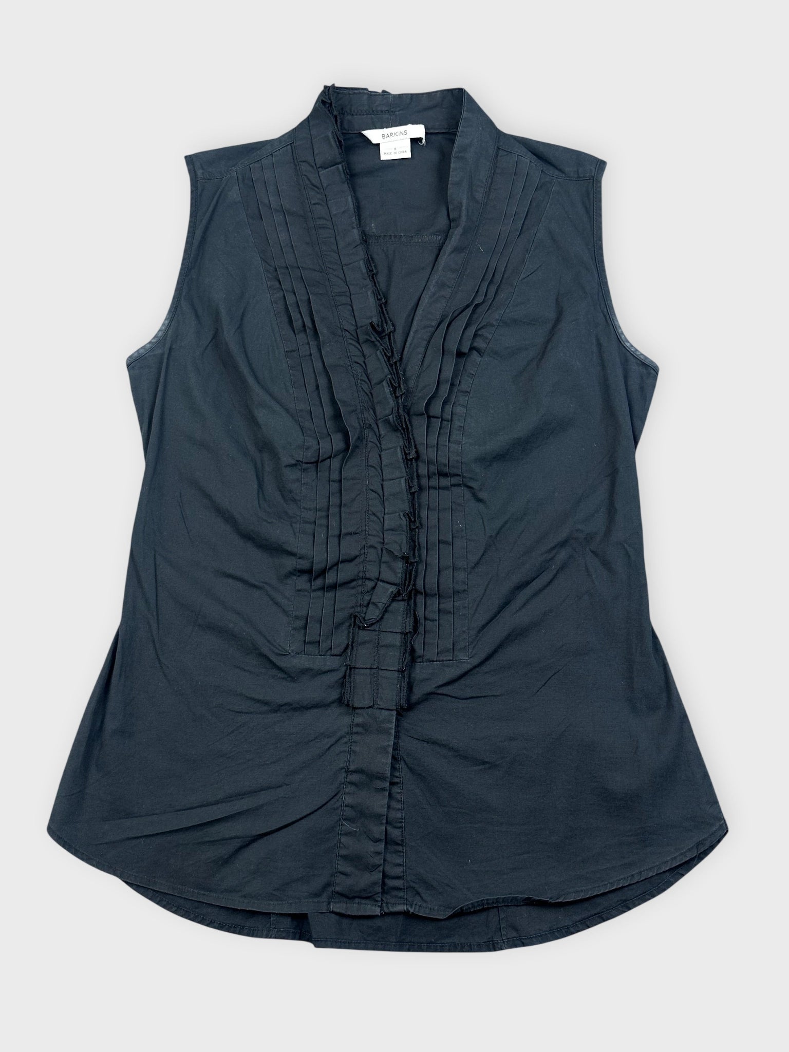 Black sleeveless ruffled top with pleated detail front view