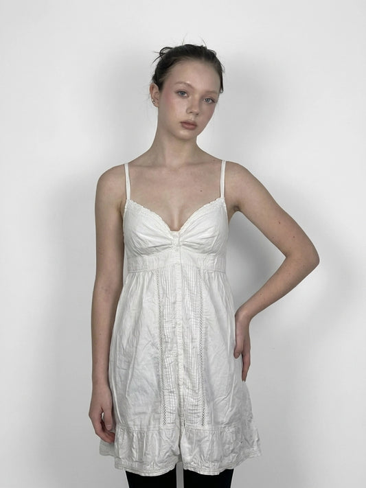 Chic white cotton strap dress with lace trim, front view.