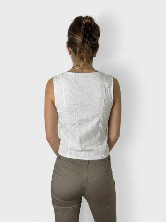 Back view of a white linen top featuring a lace-up detail.