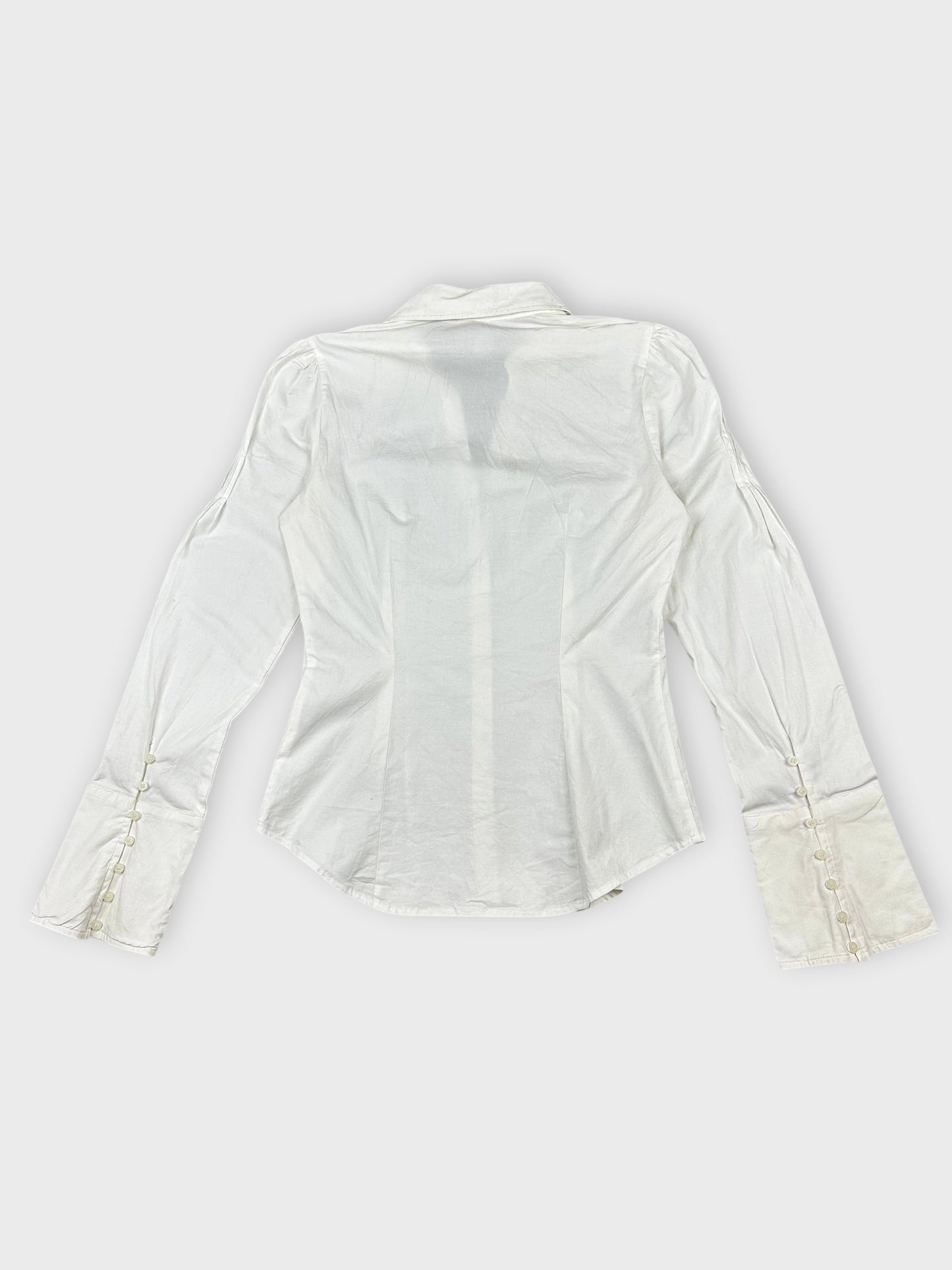 Back view of white long sleeve button-up shirt with decorative buttons on sleeves.