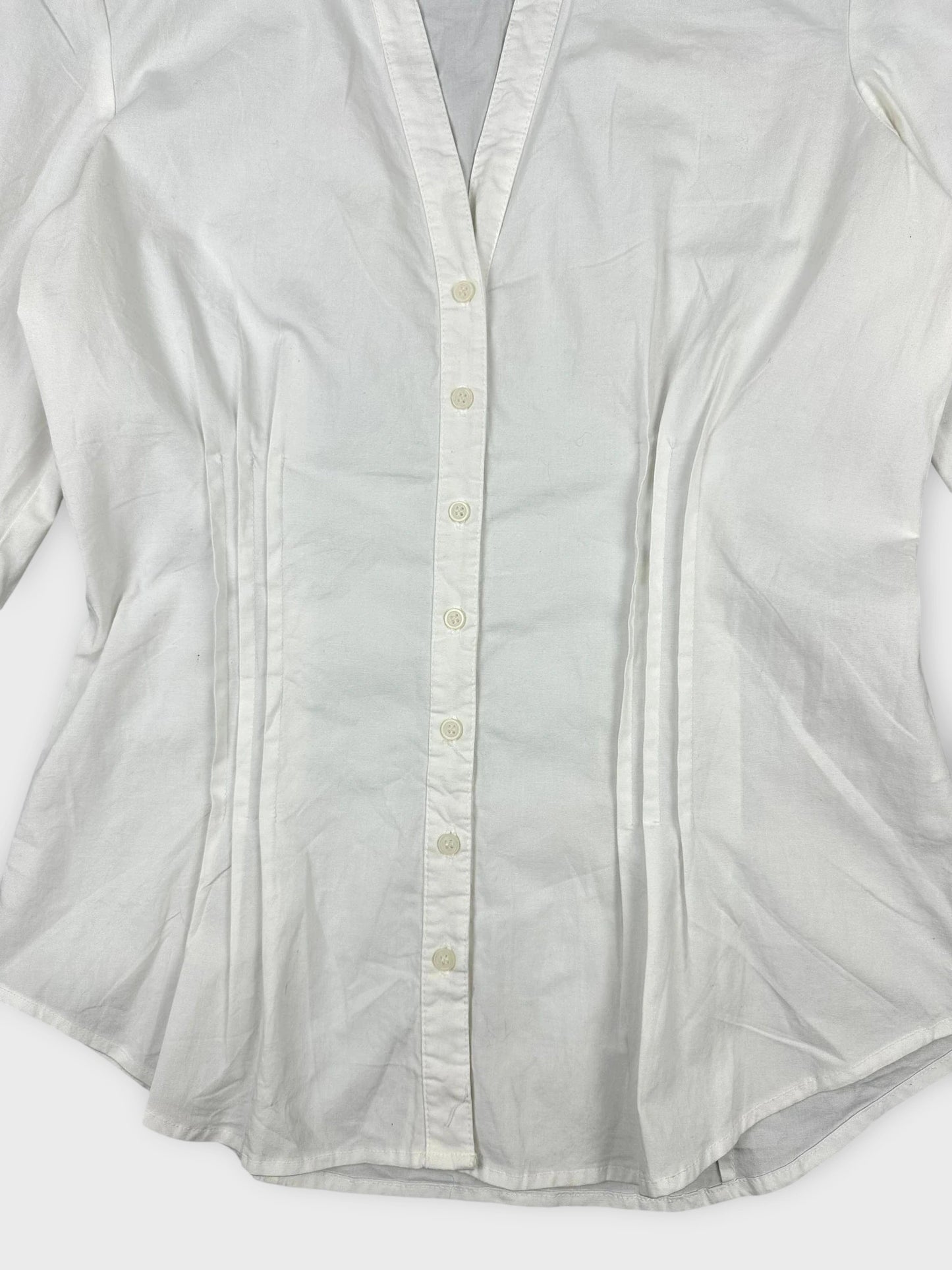 White long sleeve button-up shirt detail view with a classic collar and tailored fit.