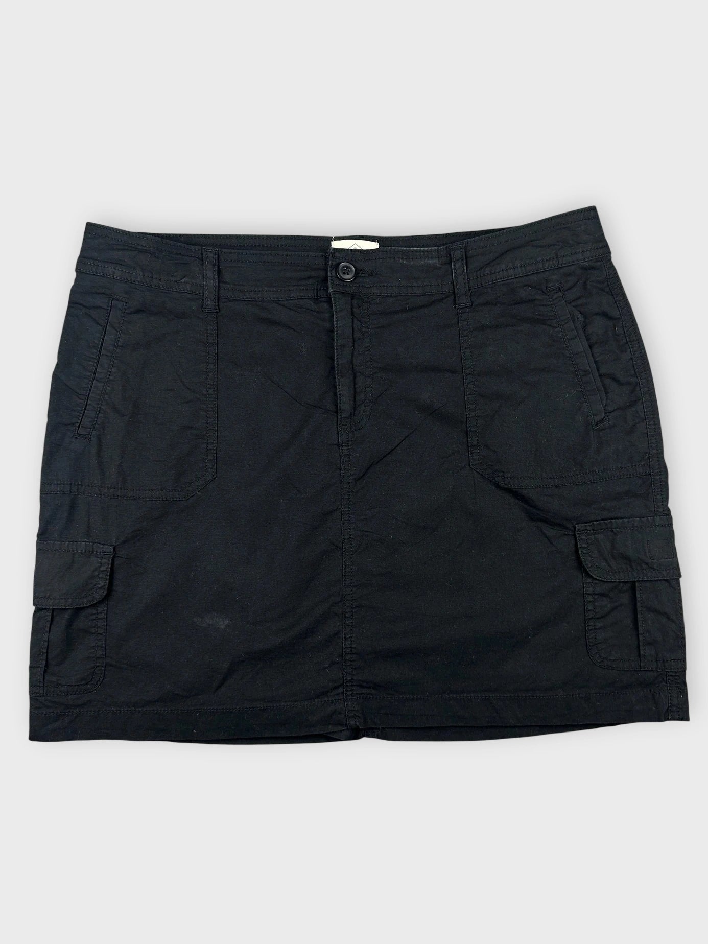 Front view of black mini cargo shorts featuring side pockets.