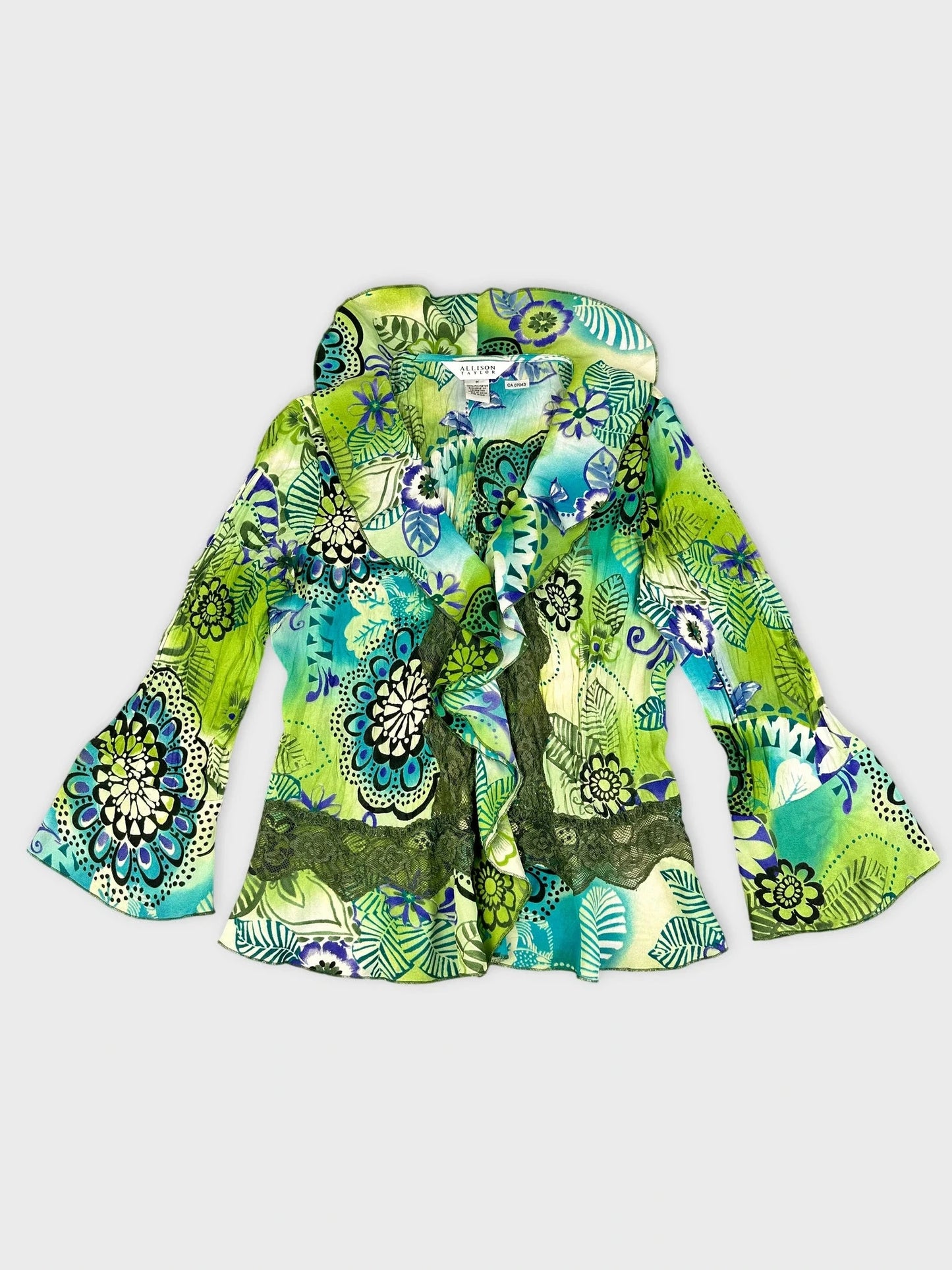 Front view of a green floral ruffle blouse with bell sleeves.