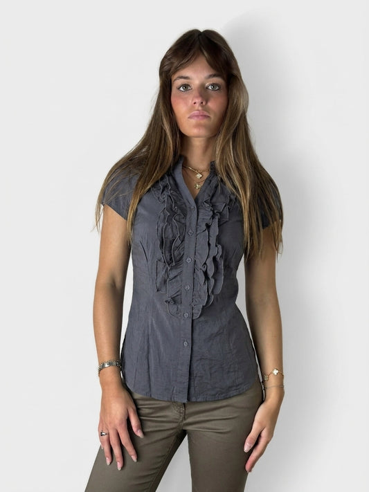 Dark gray button-up shirt with ruffled detail, front view.
