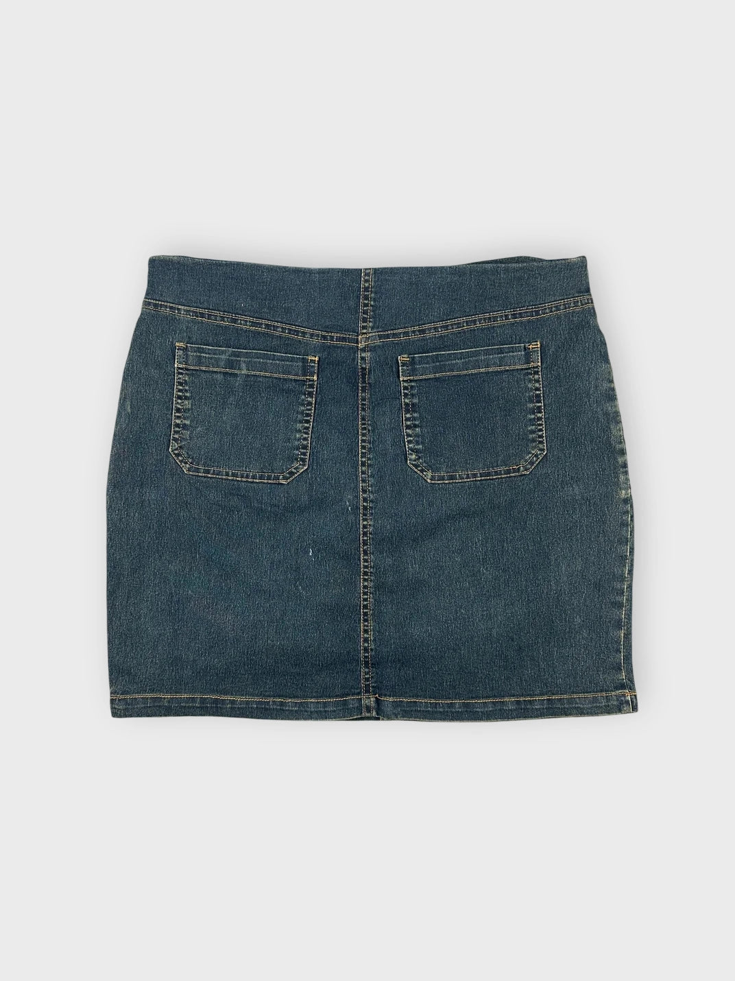 Denim mini skirt back view with two pockets and a belted detail.